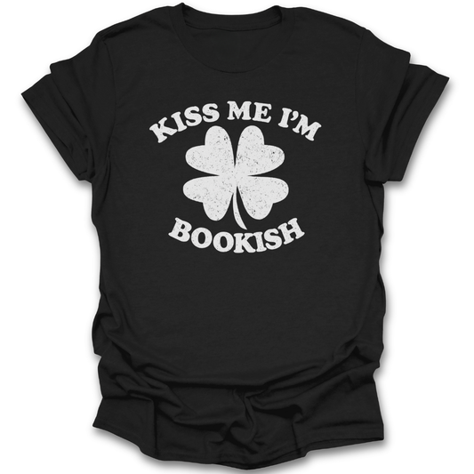 Black t-shirt with white four-leaf clover graphic and 'Kiss Me I'm Bookish' text on a white background st patricks day funny book reading literary t shirt