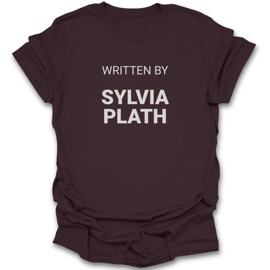 Brown t-shirt with 'WRITTEN BY SYLVIA PLATH' text on a white background poetry funny book reading literary t shirt