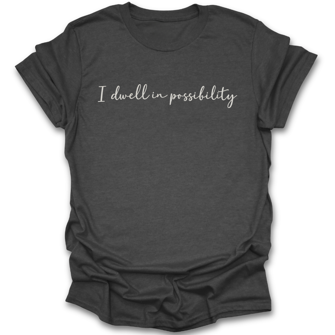Dark gray t-shirt with 'I dwell in possibility' text on a white background Emily Dickinson shirt, I dwell in possibility shirt, poetry lover shirt, bookish shirt, literary quote shirt, poet shirt, classic literature shirt, librarian gift, English teacher gift, dark academia shirt, book lover gift.