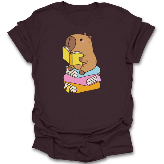 Brown t-shirt with a cartoon capybara reading a book design on a white background funny book reading literary t shirt