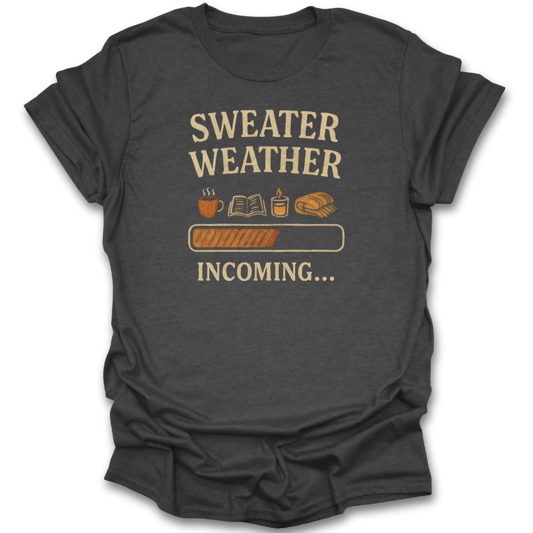 Dark gray t-shirt with 'Sweater Weather Incoming' text and graphics on a white background cozy autumn fall reading t shirt