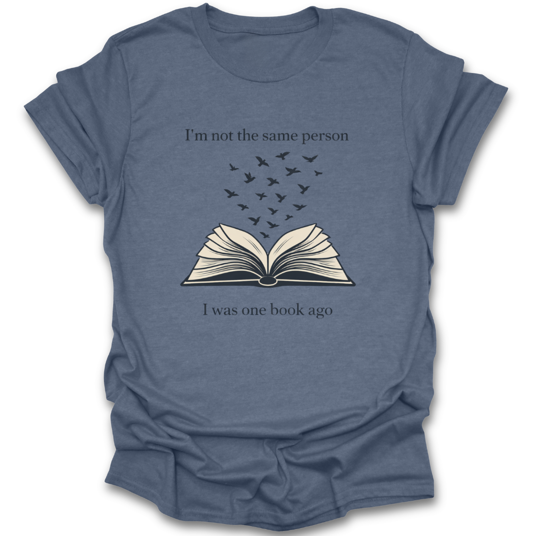 Blue t-shirt with an open book graphic and text on a white background book reading literary t shirt