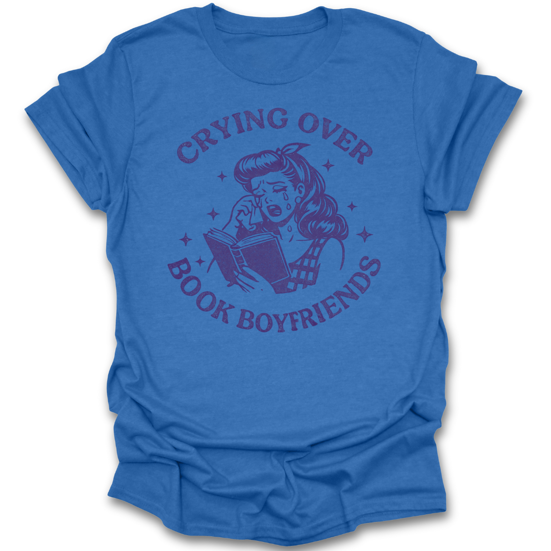 Blue t-shirt with graphic design and text 'Crying Over Book Boyfriends' on a white background romance book t shirt