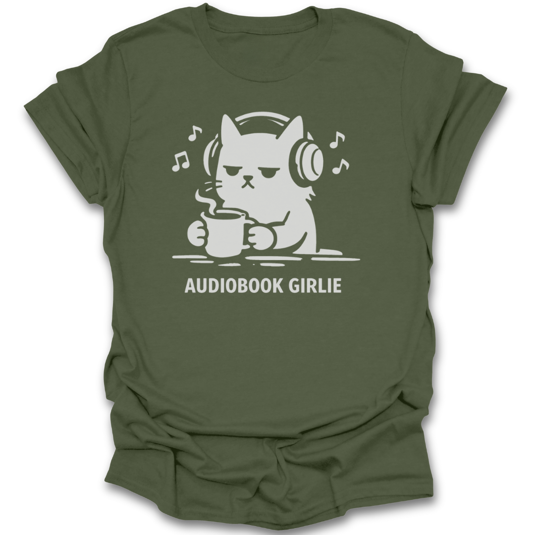 Green t-shirt with a graphic of a cat wearing headphones and holding a mug, with 'Audiobook Girlie' text. funny reading t shirt