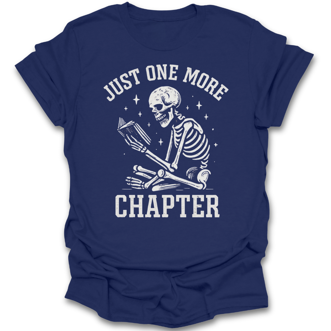 Blue t-shirt with skeleton reading a book graphic and text 'Just One More Chapter' on a white background funny book reading t shirt