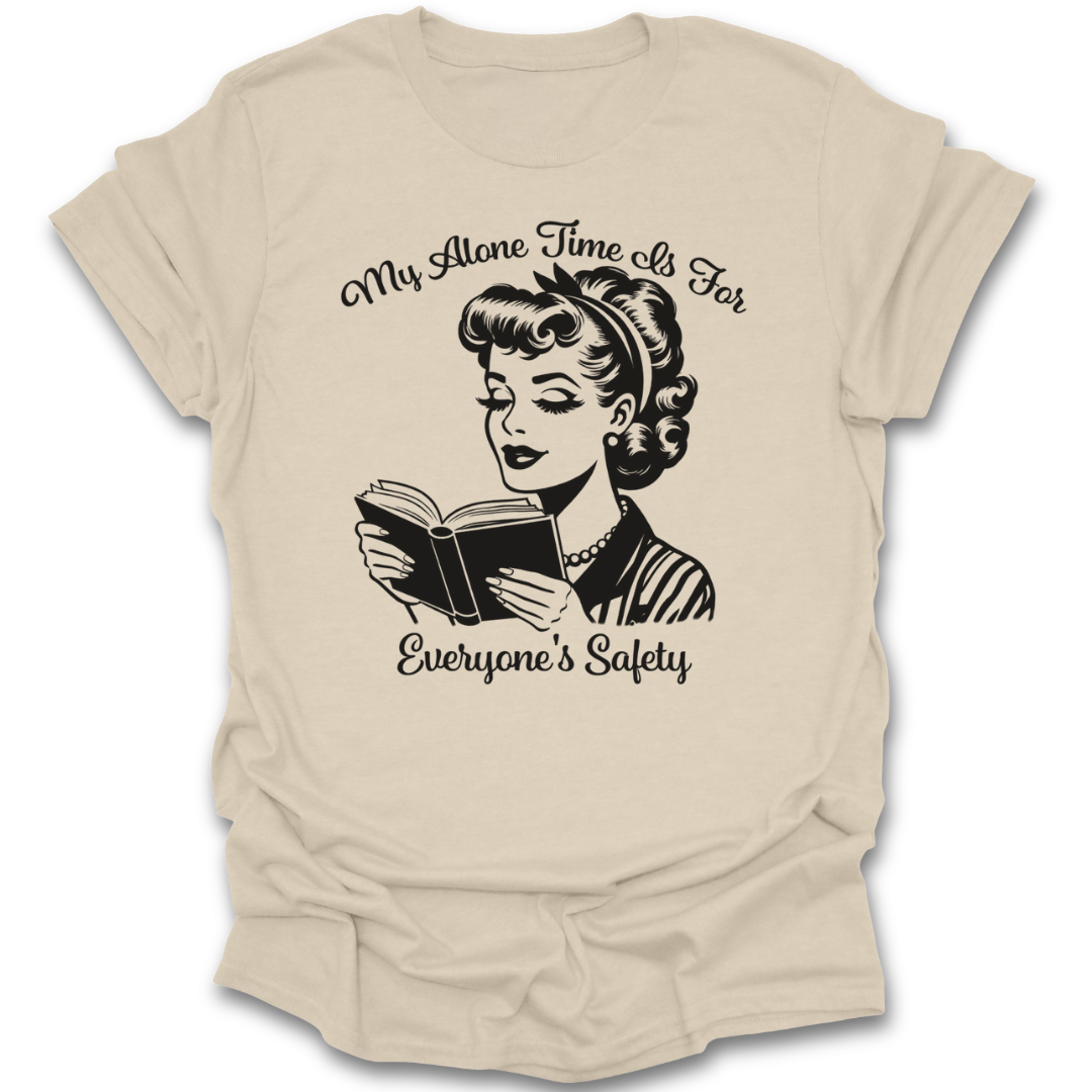 Beige t-shirt with a graphic of a woman reading a book and text 'My Alone Time Is For Everyone's Safety' on a white background. funny book reading literary t shirt