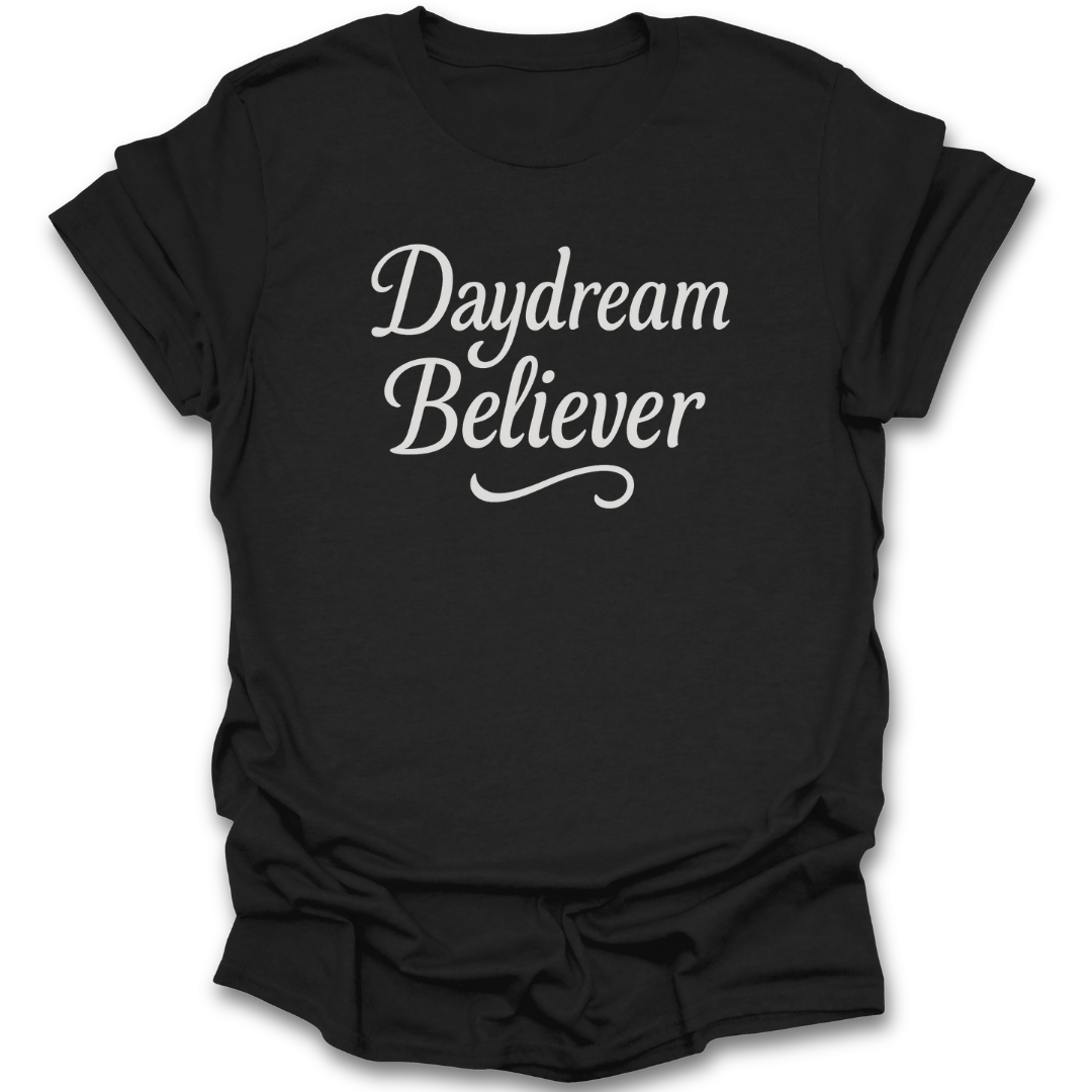 Black t-shirt with 'Daydream Believer' text on a white background