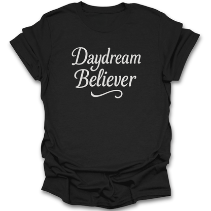 Black t-shirt with 'Daydream Believer' text on a white background