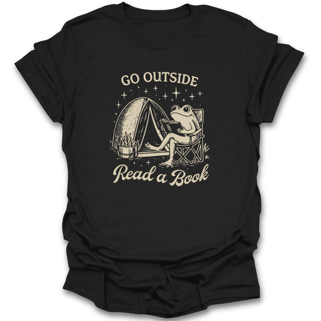 Black t-shirt with a graphic of a frog reading a book next to a tent and text 'Go Outside Read a Book' on a white background. funny book reading literary t shirt