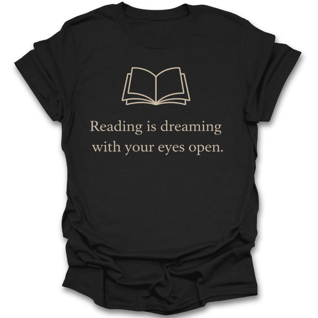 Black t-shirt with white text and book icon on a white background reading is dreaming book literary t shirt