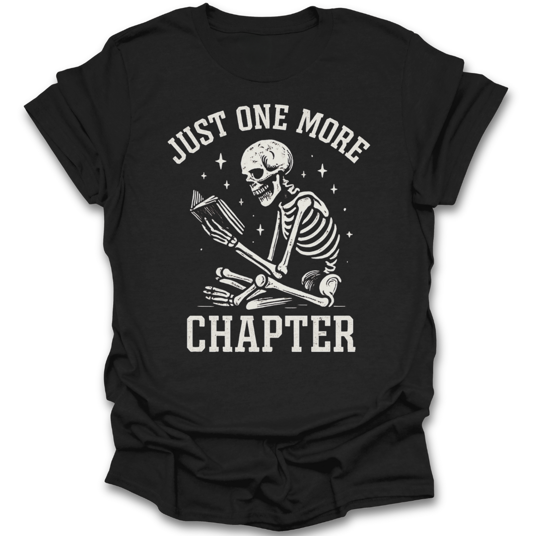 Black t-shirt with a skeleton reading a book and 'Just One More Chapter' text on a white background funny book reading literary t shirt