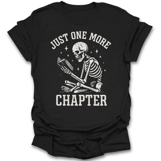 Black t-shirt with a skeleton reading a book and 'Just One More Chapter' text on a white background funny book reading literary t shirt