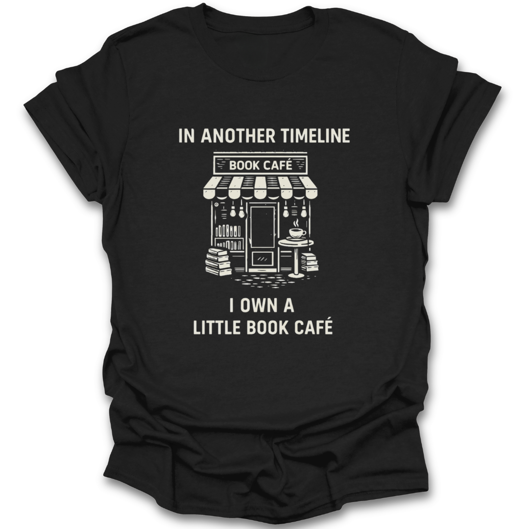 Black t-shirt with white graphic and text 'In another timeline I own a little book café' on a white background funny book reading literary t shirt