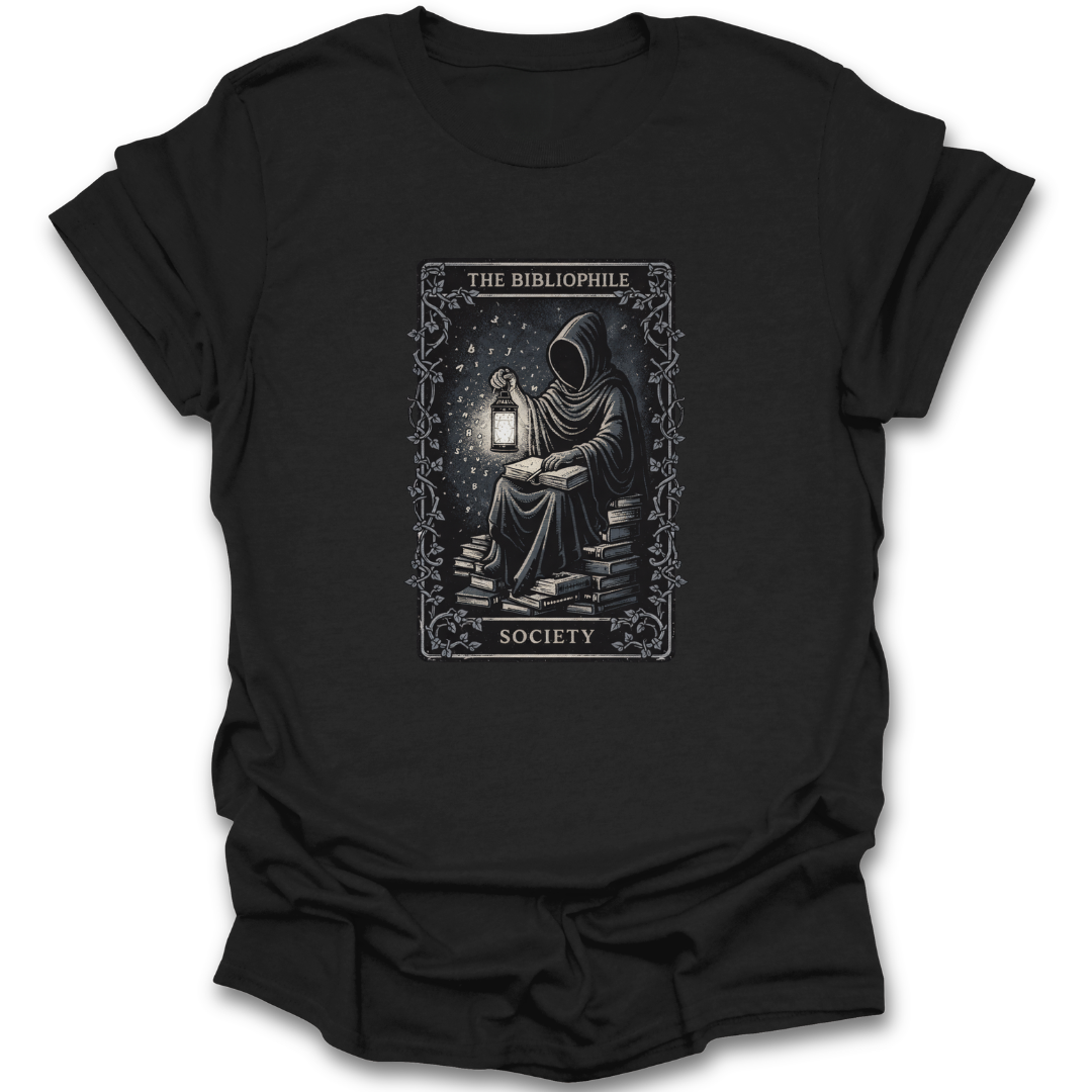 Black t-shirt with a graphic design of a person reading a book by a lantern, labeled 'The Bibliophile Society'.  book reading literary t shirt