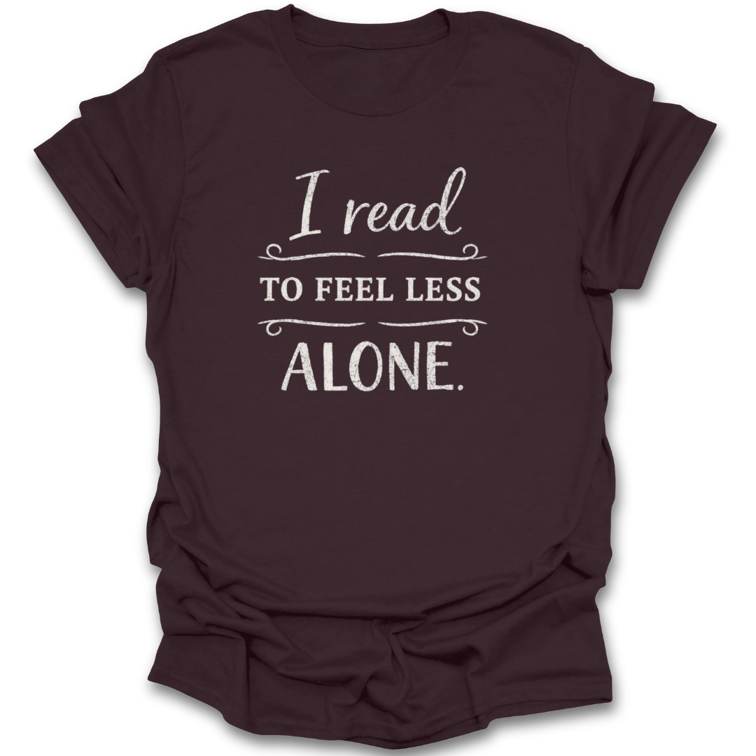 Brown t-shirt with white text 'I read to feel less alone' on a white background book reading literary t shirt