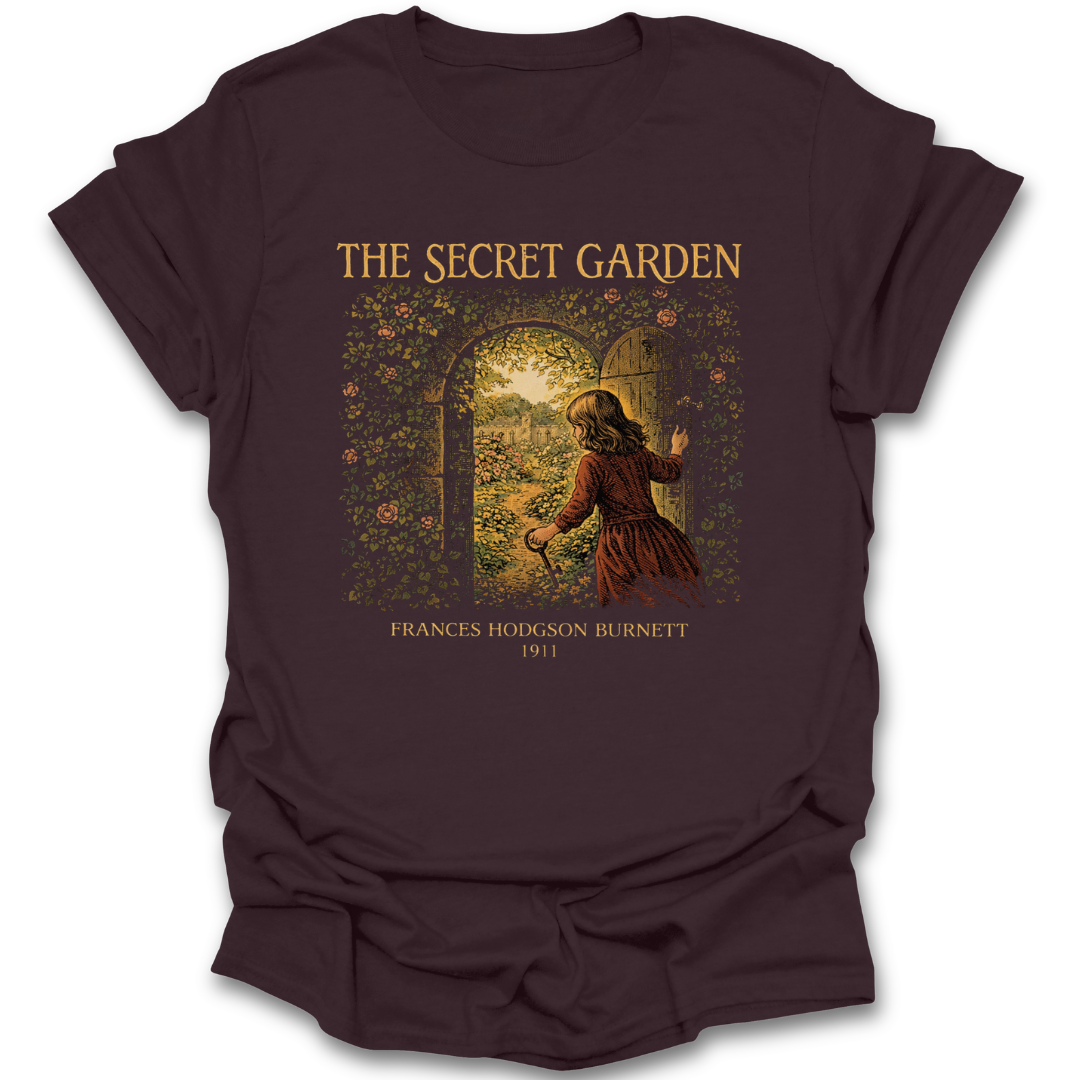 Brown t-shirt with 'The Secret Garden' graphic design on a white background. he secret garden shirt, frances hodgson burnett shirt, classic book t-shirt, literary shirt, book lover gift, children’s literature shirt, vintage book tee, reader apparel, librarian gift, teacher gift