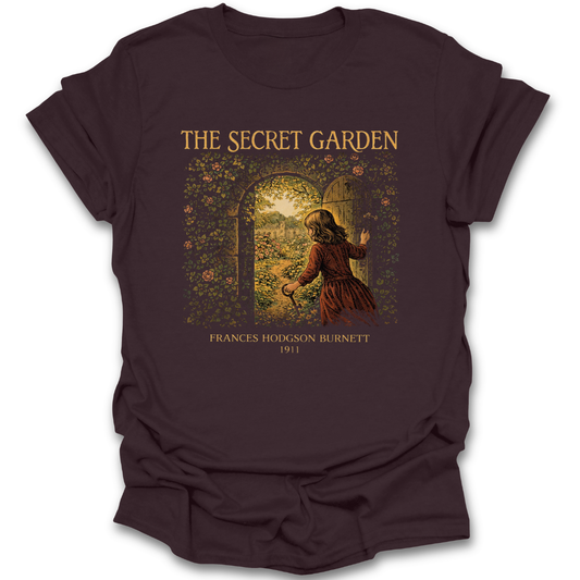Brown t-shirt with 'The Secret Garden' graphic design on a white background. he secret garden shirt, frances hodgson burnett shirt, classic book t-shirt, literary shirt, book lover gift, children’s literature shirt, vintage book tee, reader apparel, librarian gift, teacher gift
