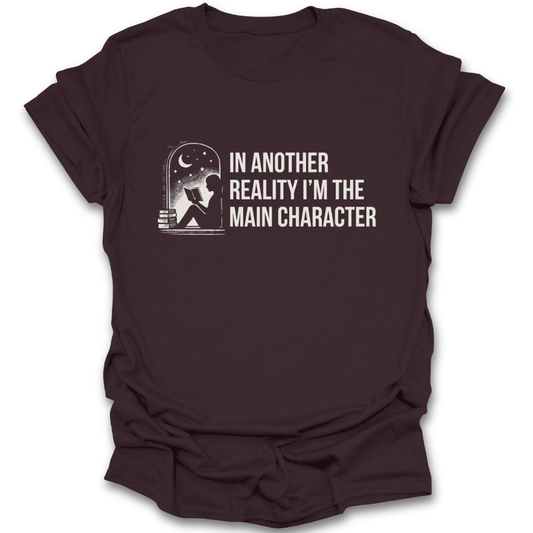 Brown t-shirt with graphic and text 'In another reality I'm the main character' on a white background funny book reading literary t shirt