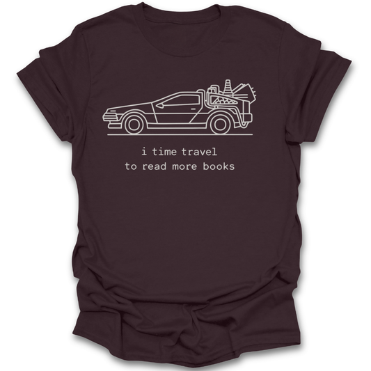 Brown t-shirt with a graphic of a car and text 'i time travel to read more books' on a white background science fiction sci fi funny book reading literary t shirt