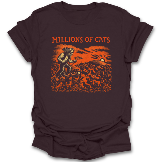 Brown t-shirt with 'Millions of Cats' graphic design on a white background. millions of cats shirt, classic picture book shirt, children’s literature shirt, vintage illustration t-shirt, book lover shirt, cat lover book shirt, librarian gift, teacher gift, literary t-shirt, classic book apparel