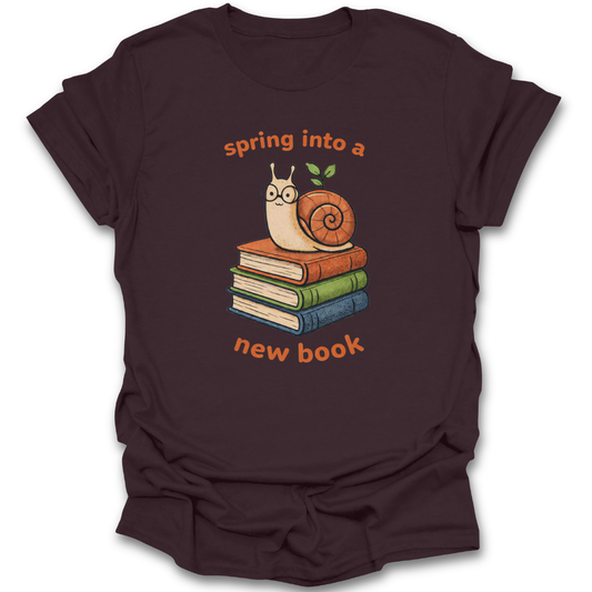 Brown t-shirt with a snail and books graphic and text 'spring into a new book' on a white background funny book reading literary t shirt