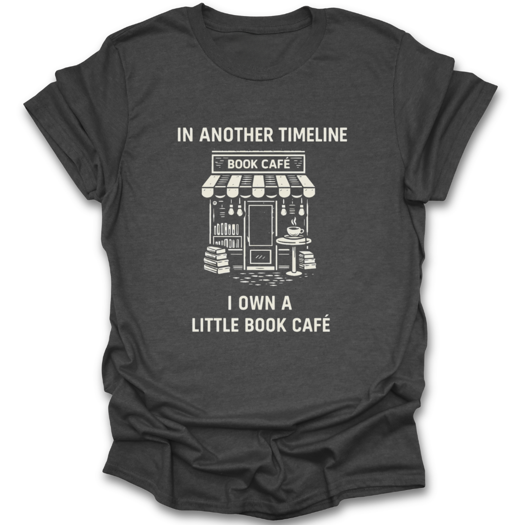 Black t-shirt with white graphic and text 'In another timeline I own a little book café' on a white background funny book reading literary t shirt