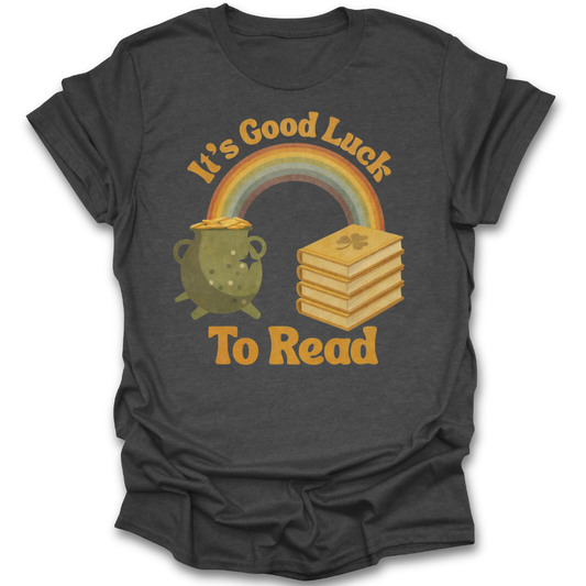 Dark gray t-shirt with a graphic of a rainbow, pot of gold, and books with 'It's Good Luck To Read' text. st patricks day funny book reading literary t shirt