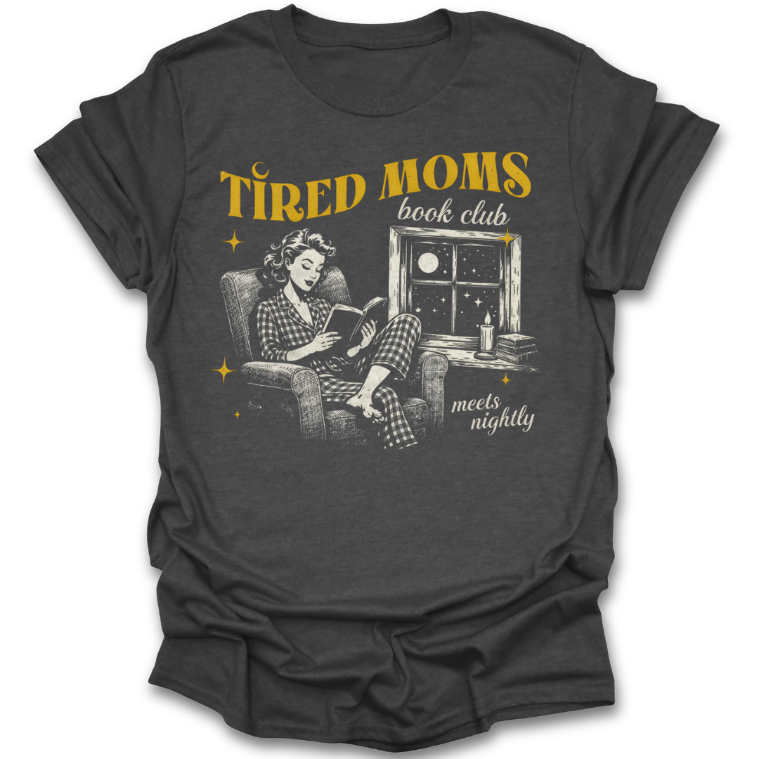 Dark gray t-shirt with graphic of a woman reading a book and text 'Tired Moms book club meets nightly' on a white background. funny book reading literary t shirt
