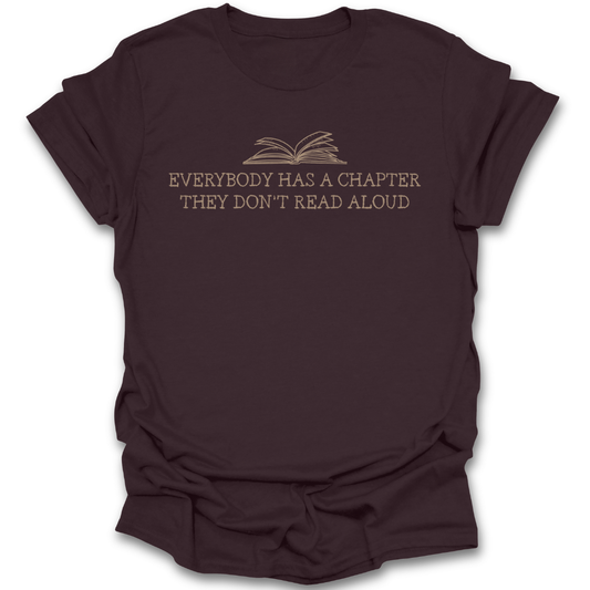 Brown t-shirt with text and book graphic on a white background