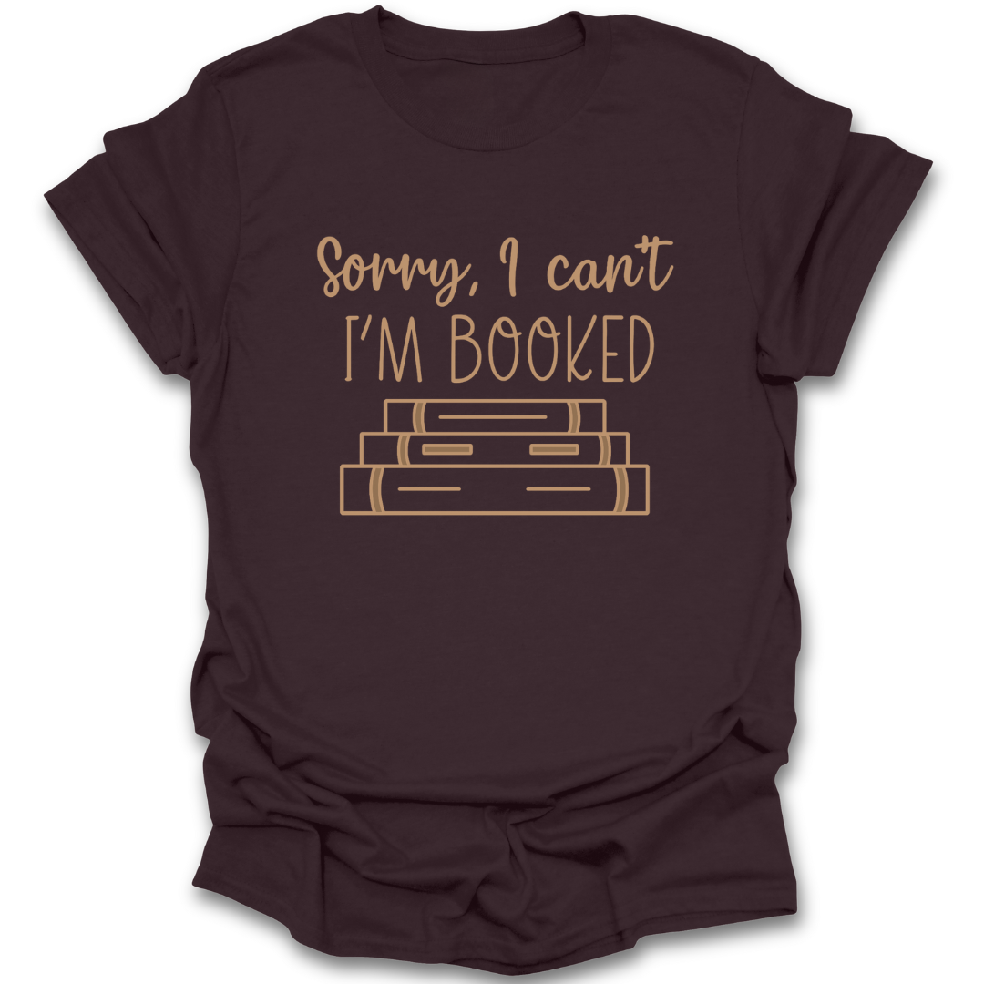 Brown t-shirt with 'Sorry, I can't I'm booked' text and book illustration on a white background funny book reading t shirt