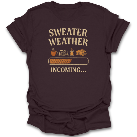 Brown t-shirt with 'Sweater Weather Incoming' text and graphics on a white background funny book reading literary t shirt