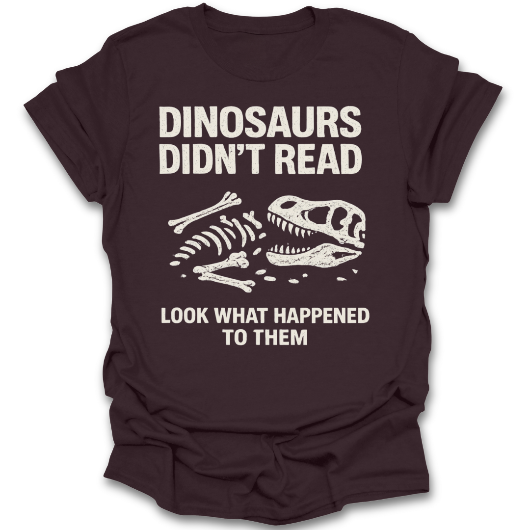 Brown t-shirt with dinosaur skeleton graphic and text on a white background funny reaing book t shirt