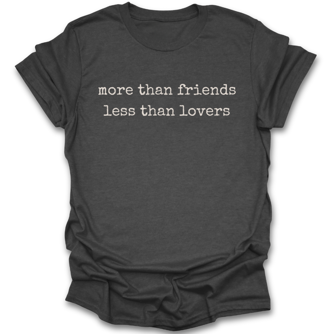Dark gray t-shirt with white text 'more than friends less than lovers' on a white background romance  funny book reading literary t shirt