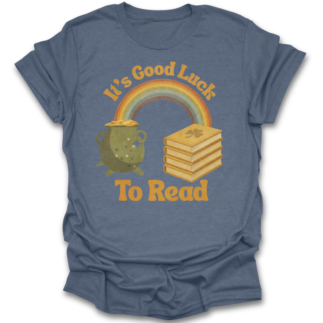 Blue t-shirt with a graphic of a rainbow, pot of gold, and books with text 'It's Good Luck To Read' on a white background. st patricks day funny book reading literary t shirt