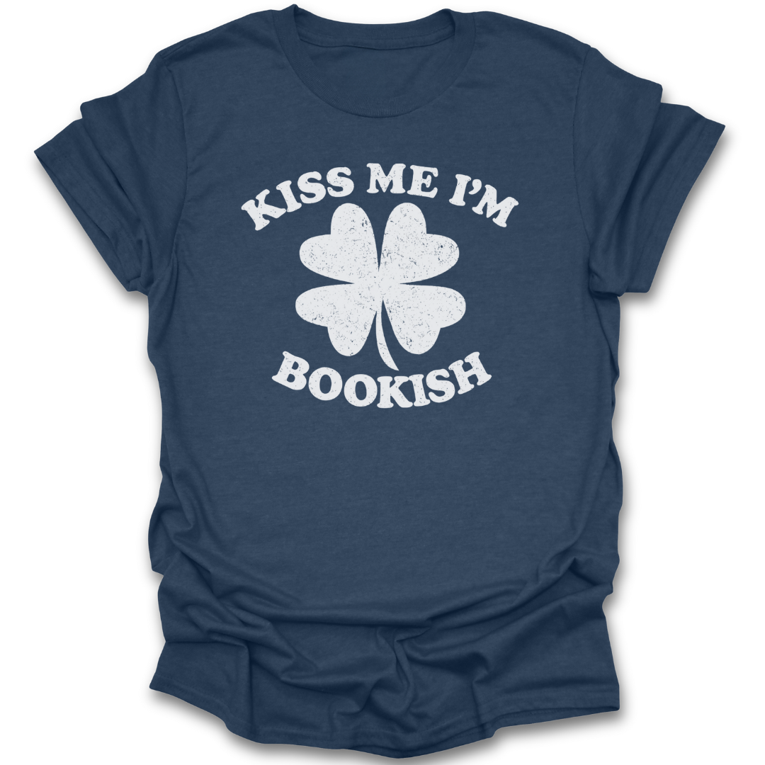Navy blue t-shirt with white four-leaf clover graphic and 'Kiss Me I'm Bookish' text on a white background st patricks day funny book reading literary t shirt