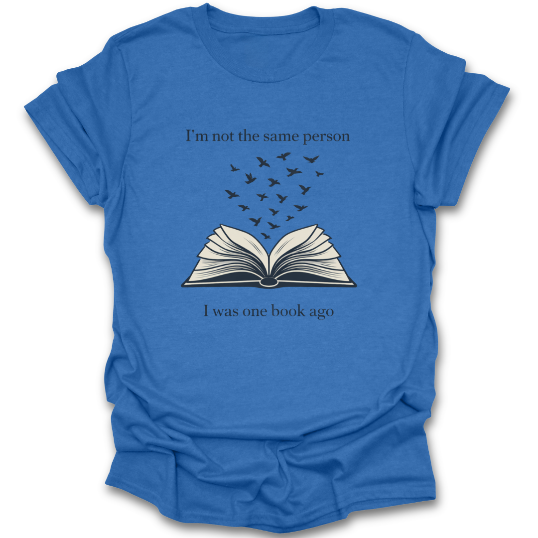 Blue t-shirt with an open book graphic and text on a white background book reading literary t shirt
