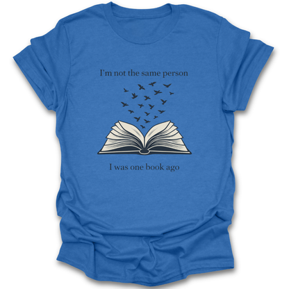 Blue t-shirt with an open book graphic and text on a white background book reading literary t shirt