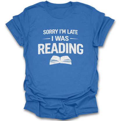 Blue t-shirt with white text 'Sorry I'm late I was reading' on a white background funny book reading literary t shirt