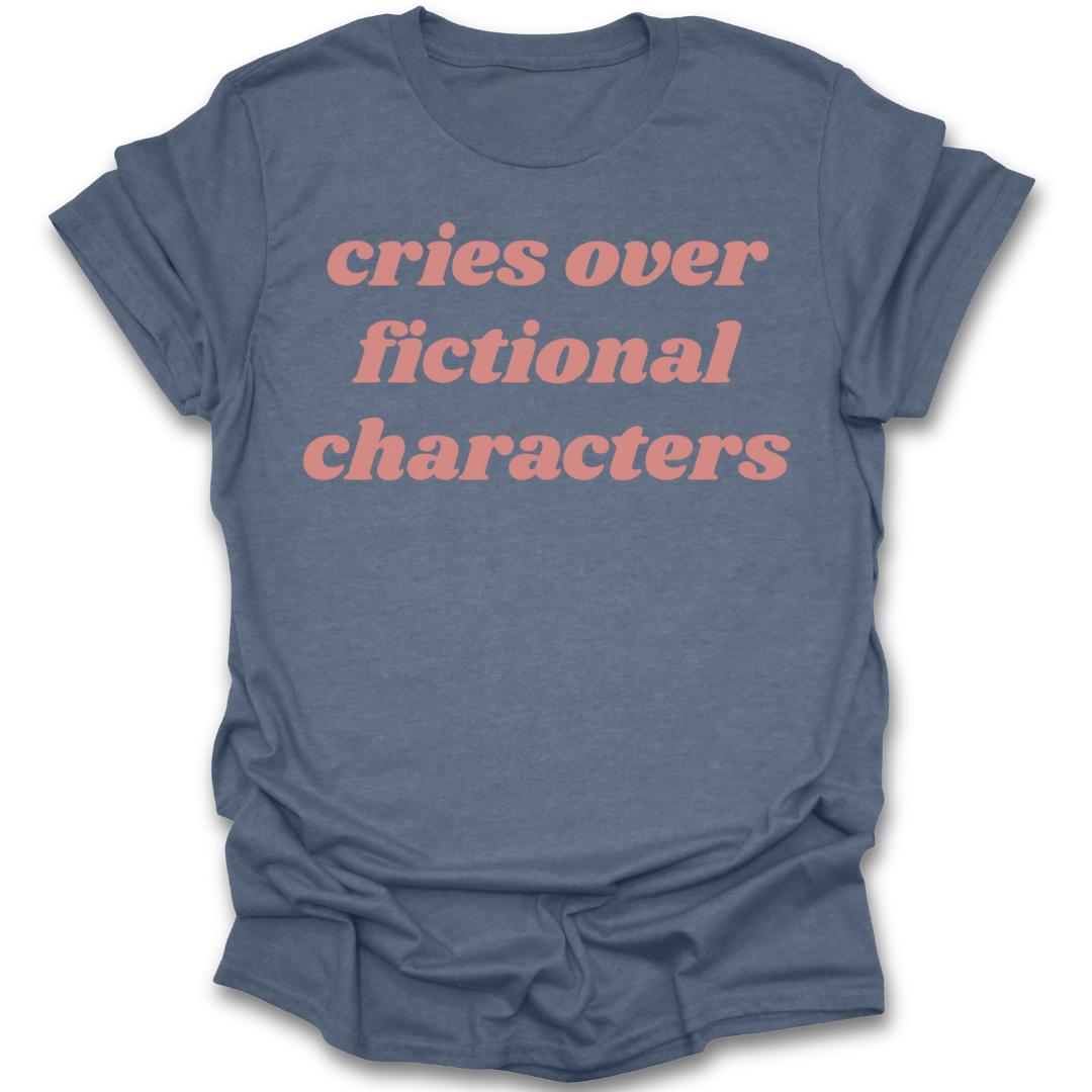 Blue t-shirt with pink text 'cries over fictional characters' on a white background romance book t shirt