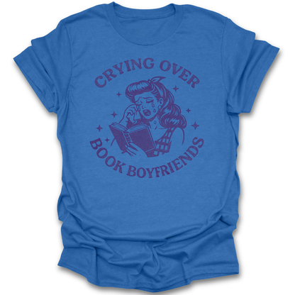Blue t-shirt with graphic design and text 'Crying Over Book Boyfriends' on a white background romance book t shirt