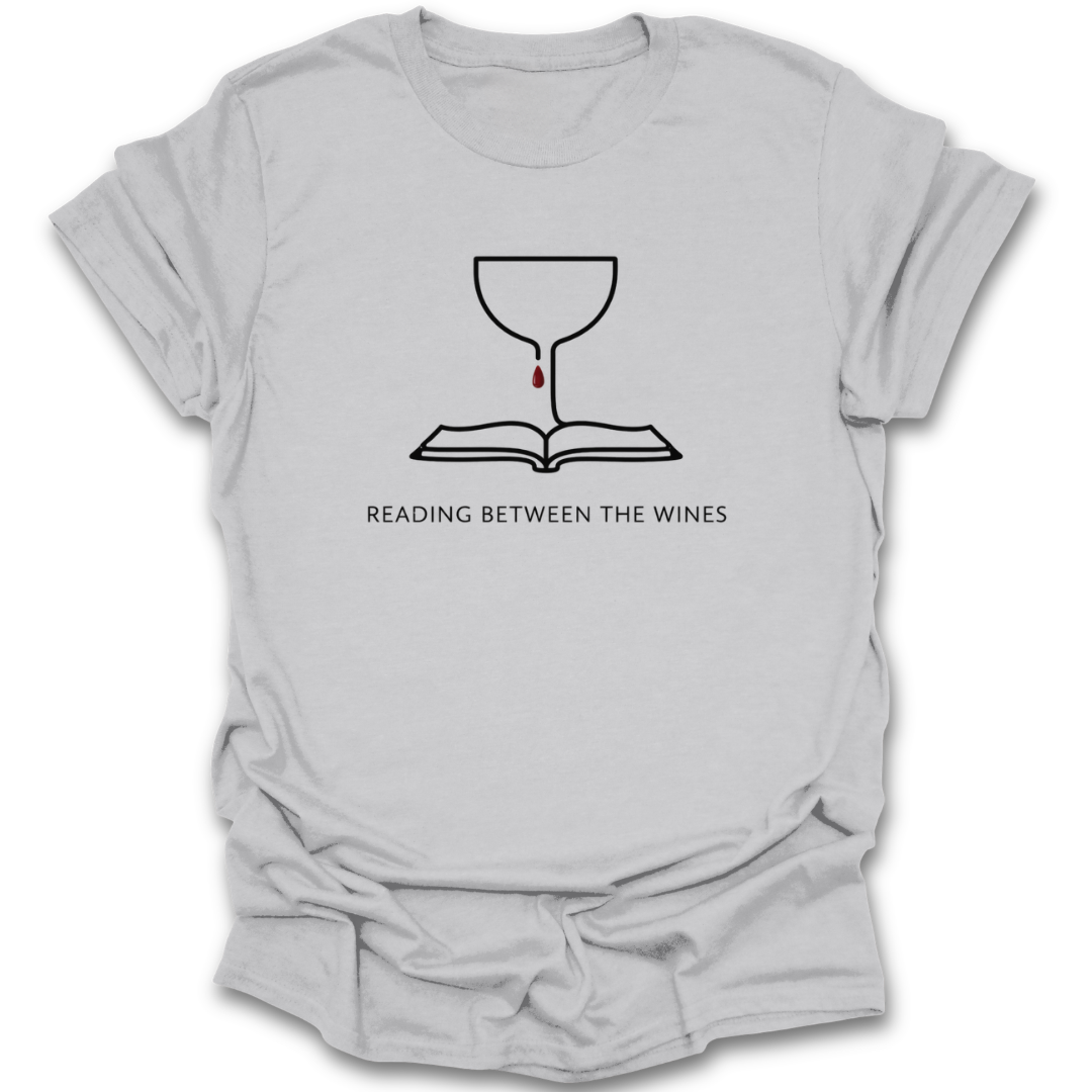 Gray t-shirt with a graphic design and text 'Reading Between The Wines' on a white background book lover shirt, reading shirt, wine lover shirt, funny book shirt, book club shirt, bibliophile gift, reader gift, bookworm shirt, literary shirt, wine and books shirt, funny reader tee, bookish apparel, bookstore shirt, librarian gift