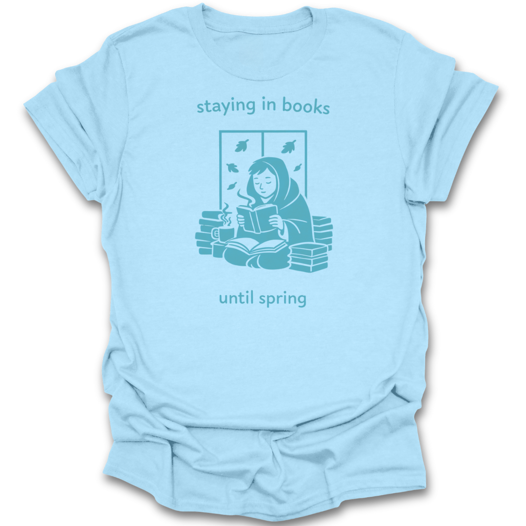 Light blue t-shirt with a graphic of a person reading a book and text 'staying in books until spring' on a white background. funny reading t shirt