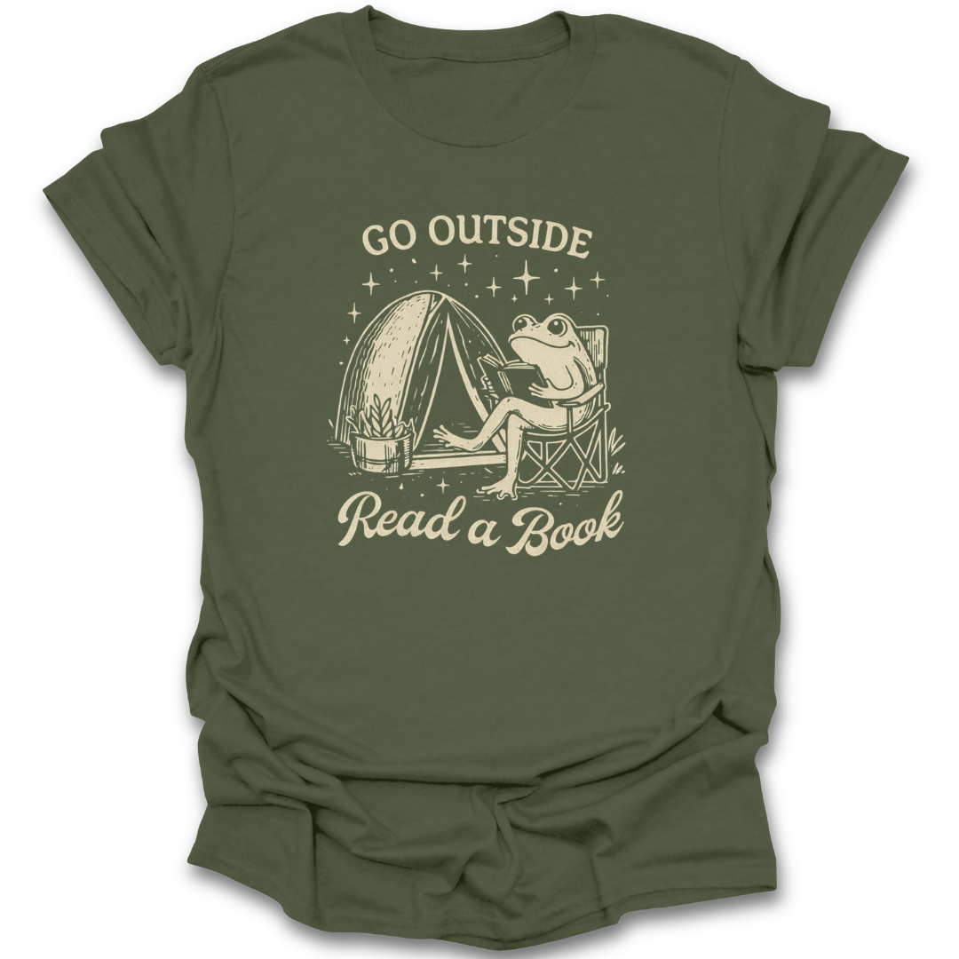 Green t-shirt with a frog reading a book graphic and text 'Go Outside Read a Book' on a white background. funny book reading literary t shirt