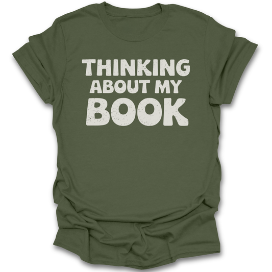 Green t-shirt with 'Thinking About My Book' text on a white background funny book reading literary t shirt