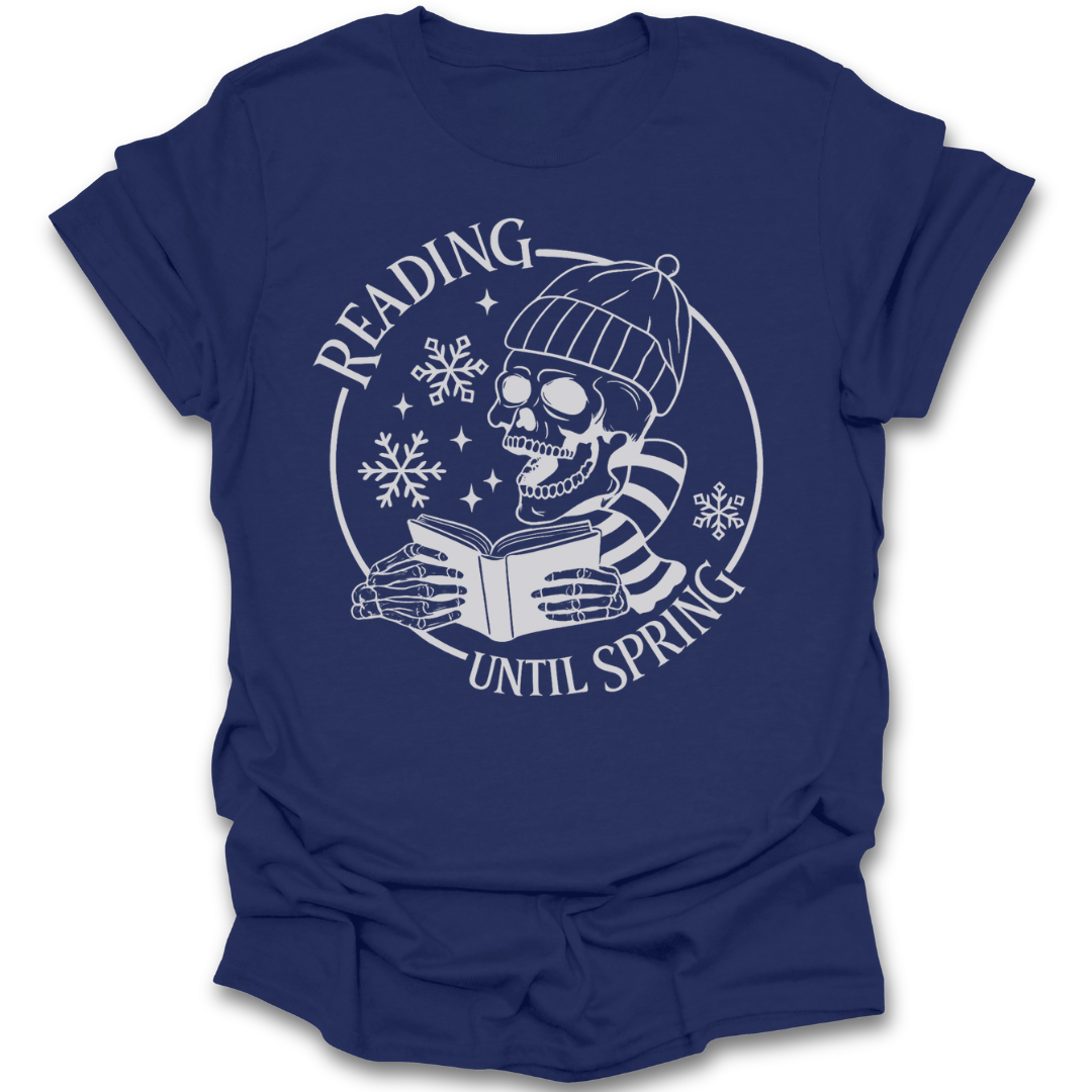 Navy blue t-shirt with a white graphic of a skull reading a book and text 'Reading Until Spring' on a white background. funny book t shirt