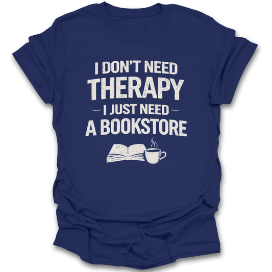 Blue t-shirt with text 'I don't need therapy, I just need a bookstore' on a white background mental health funny book reading literary t shirt