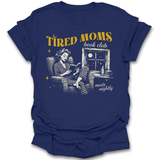 Blue t-shirt with graphic of a woman reading a book and text 'Tired Moms Book Club meets nightly' on a white background. funny book reading literary t shirt