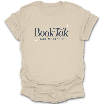 Beige t-shirt with 'BookTok Made Me Read It' text on a white background funny book reading literary t shirt