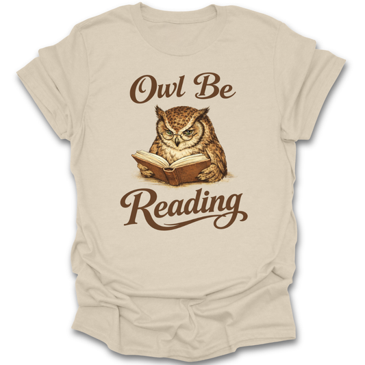 Beige t-shirt with an owl reading a book graphic and text on a white background 