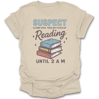 Beige t-shirt with book graphic and text on a white background  funny book reading literary t shirt crime mystery
